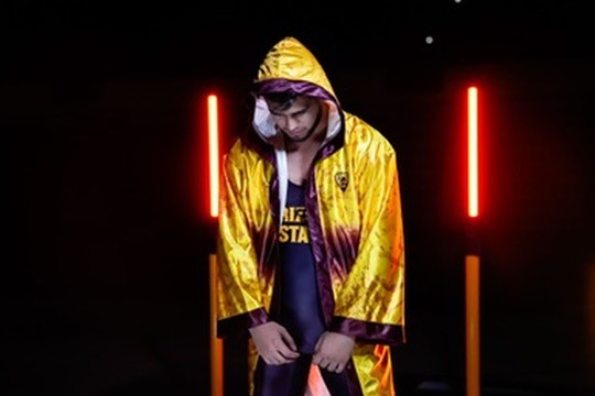 An Arizona State wrestler in a gold robe before a match