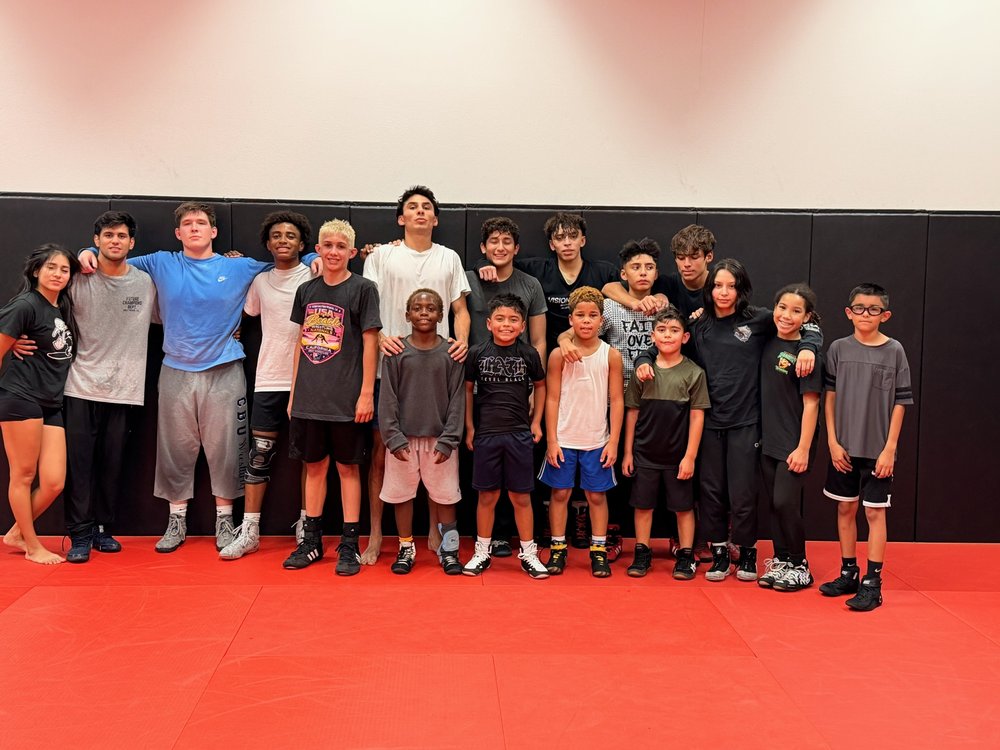Future Champions athletes and coaches smiling together after practice